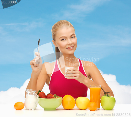 Image of young woman eating healthy breakfast