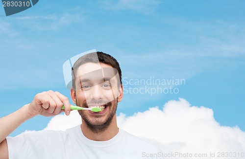 Image of smiling young man with toothbrush