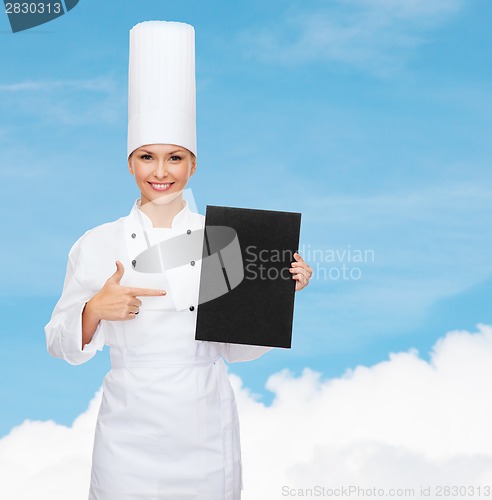 Image of smiling female chef with black blank paper