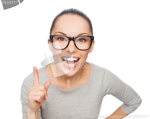 Image of asian woman in eyeglasses with finger up