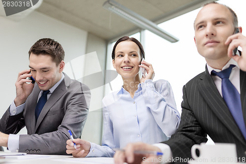 Image of business team with smartphones having conversation