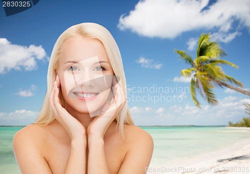 Image of face of beautiful woman touching her face skin