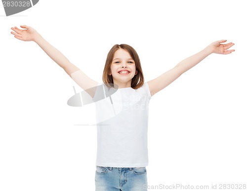 Image of smiling teenage girl with raised hands