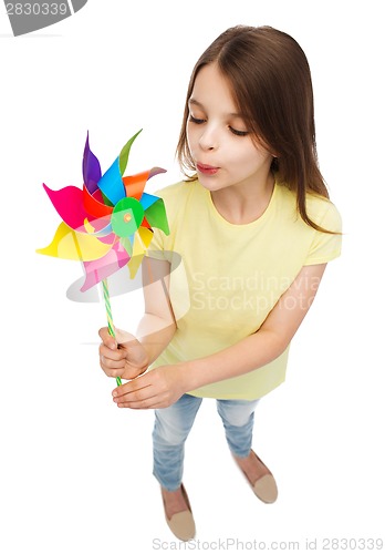 Image of smiling child with colorful windmill toy