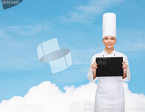 Image of smiling female chef with black blank paper