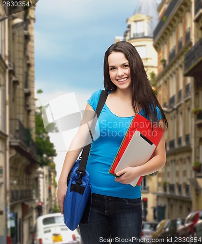 Image of smiling student with bag, folders and tablet pc