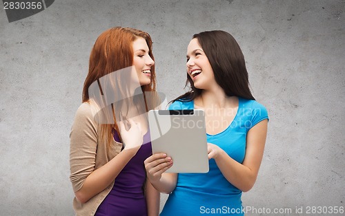 Image of two smiling teenagers with tablet pc computer