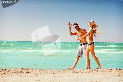 Image of couple walking on the beach