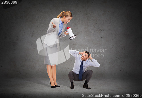 Image of angry businesswoman with megaphone