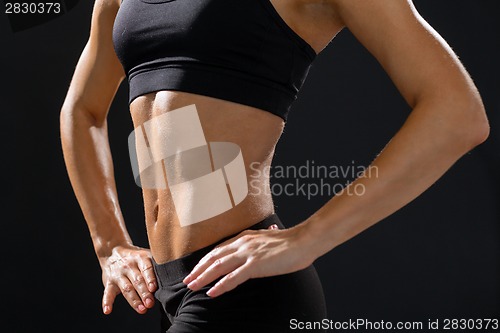 Image of close up of athletic female abs in sportswear