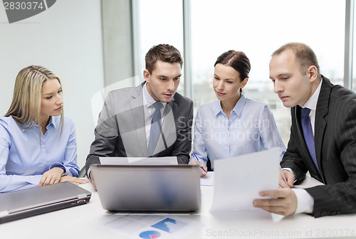 Image of business team with laptop having discussion