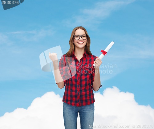 Image of smiling female student in eyeglasses with diploma