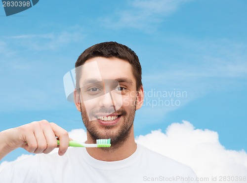 Image of smiling young man with toothbrush