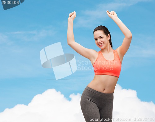 Image of smiling teenage girl in sportswear dancing