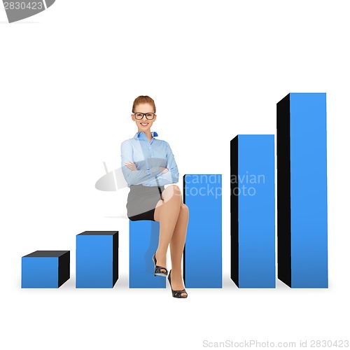 Image of smiling businesswoman in glasses sitting on chart