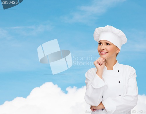 Image of smiling female chef dreaming