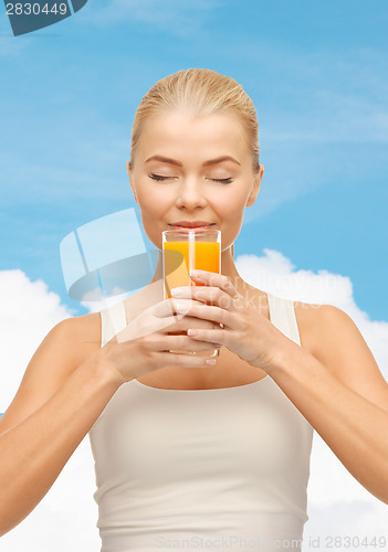 Image of young woman drinking orange juice