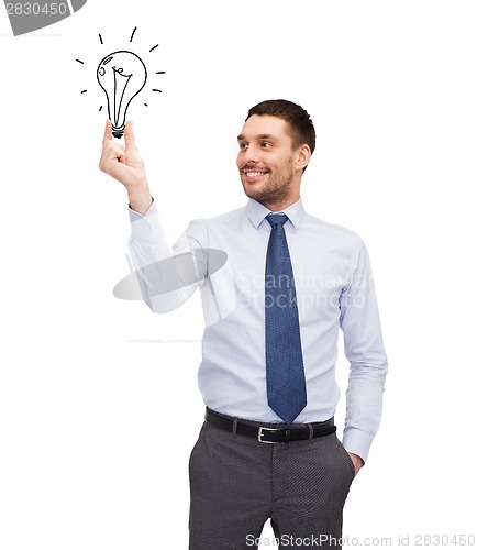 Image of handsome businessman holding light bulb