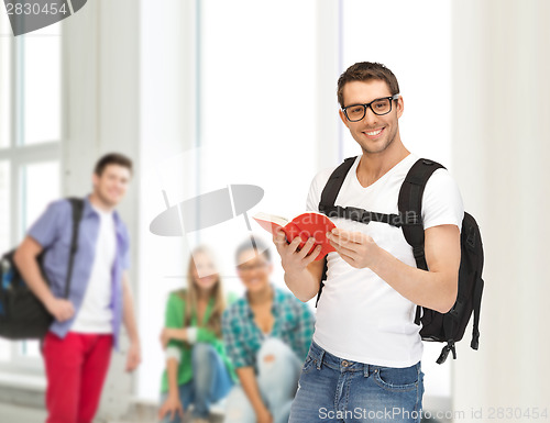 Image of travelling student with backpack and book