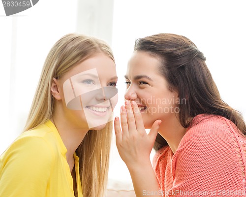 Image of one girl telling another secret