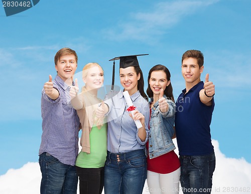 Image of group of students with diploma showing thumbs up