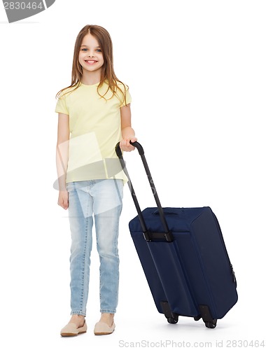 Image of smiling little girl with suitcase