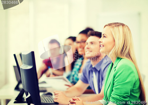 Image of students with computers studying at school