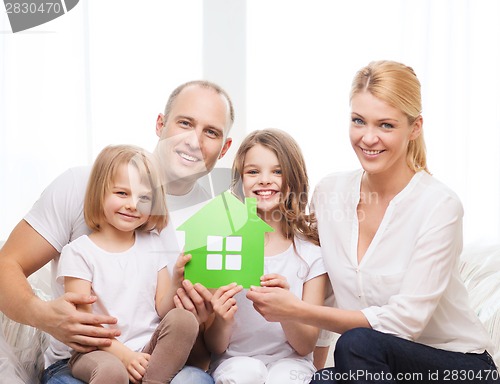 Image of smiling parents and two little girls at new home