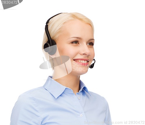 Image of friendly female helpline operator with headphones