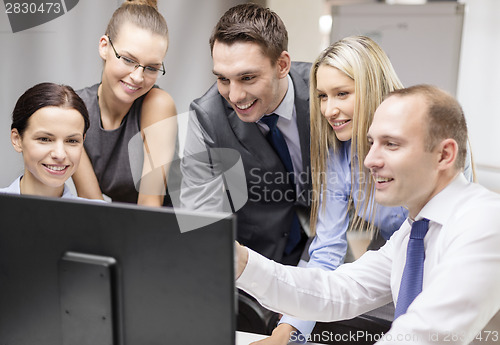 Image of business team with monitor having discussion
