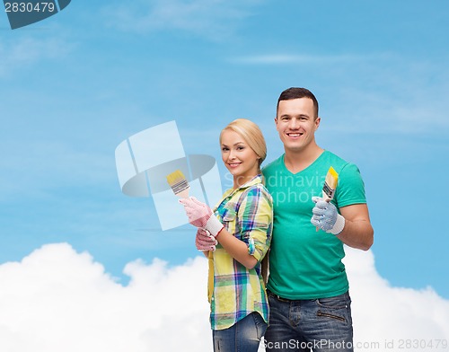 Image of smiling couple with paintbrush