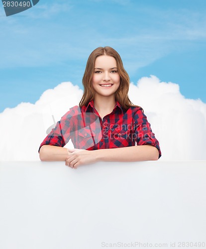 Image of smiling young teenage girl with white blank board