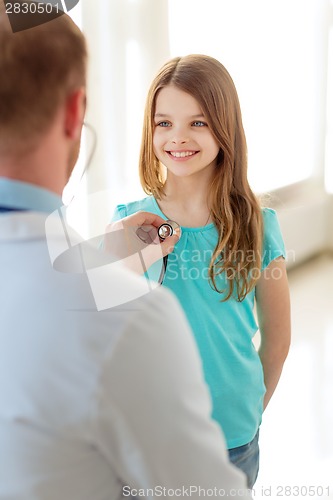 Image of male doctor with stethoscope listening to child