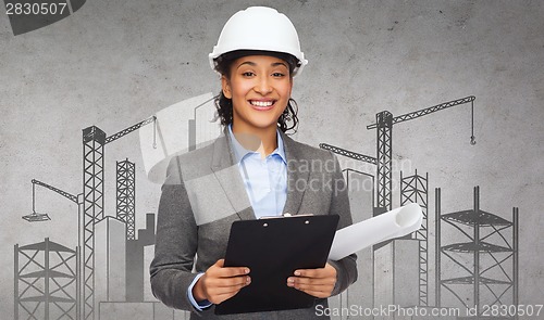 Image of businesswoman in white helmet with clipboard