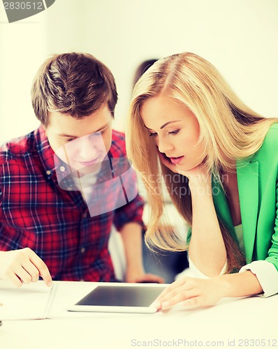 Image of students looking at tablet pc at school