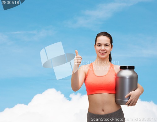 Image of teenage girl with jar of protein showing thumbs up