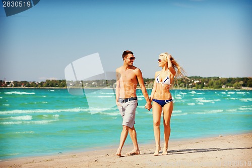 Image of couple walking on the beach