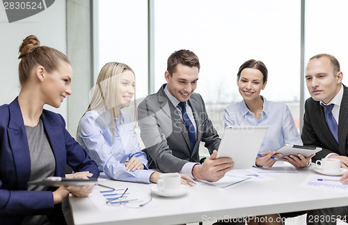 Image of business team with tablet pc having discussion