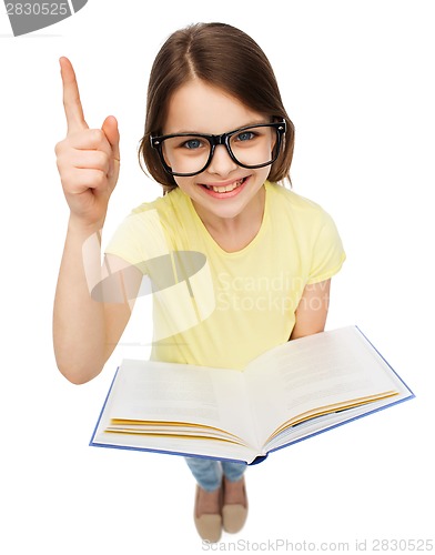 Image of smiling little girl in eyeglasses with book