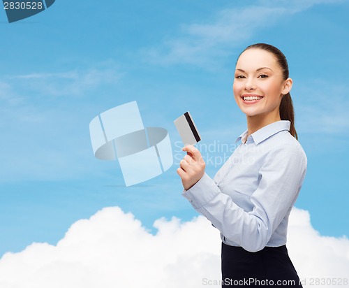Image of smiling businesswoman showing credit card