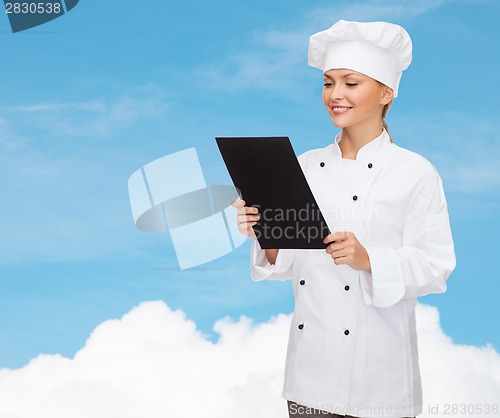 Image of smiling female chef with black blank paper