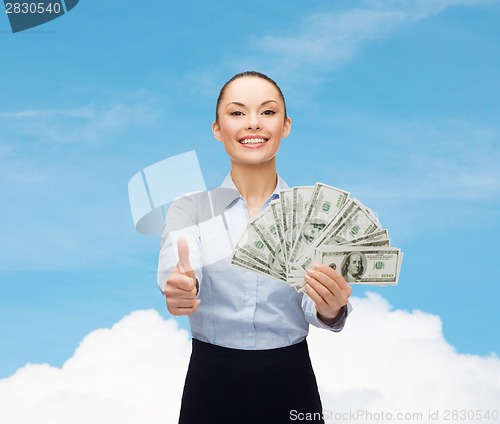 Image of young businesswoman with dollar cash money