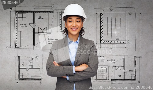 Image of businesswoman in white helmet with crossed arms