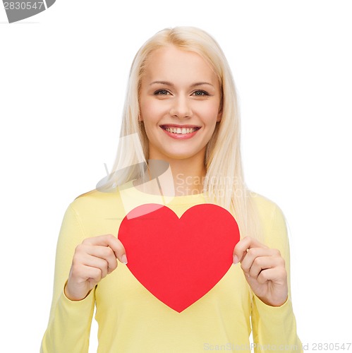 Image of smiling woman with red heart