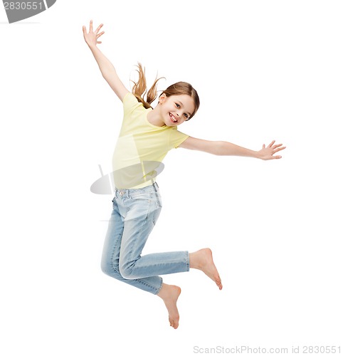 Image of smiling little girl jumping