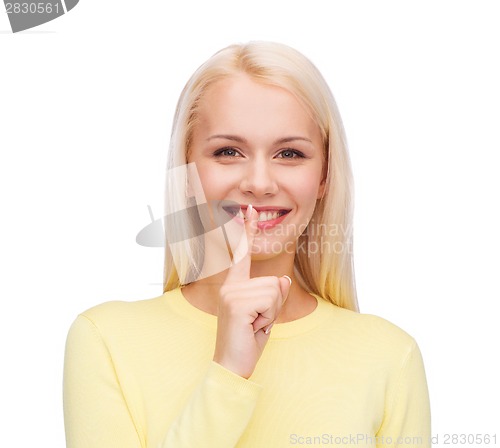 Image of young woman with finger on her lip