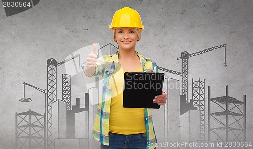 Image of smiling woman in helmet with clipboard