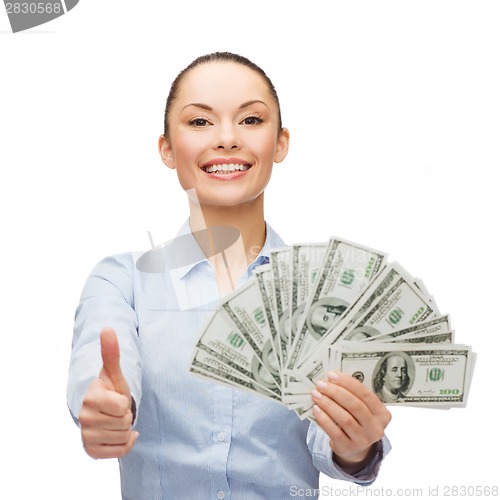 Image of young businesswoman with dollar cash money