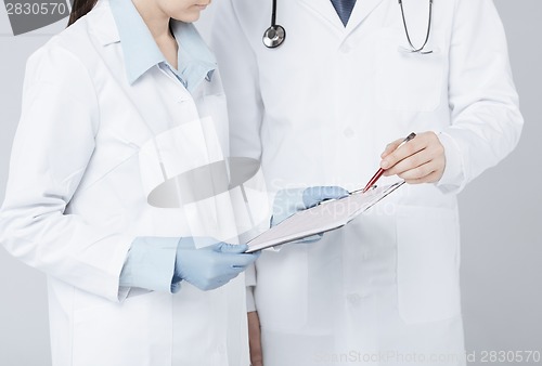Image of nurse and male doctor holding cardiogram