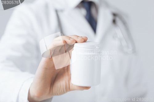 Image of doctor hands holding white pack
